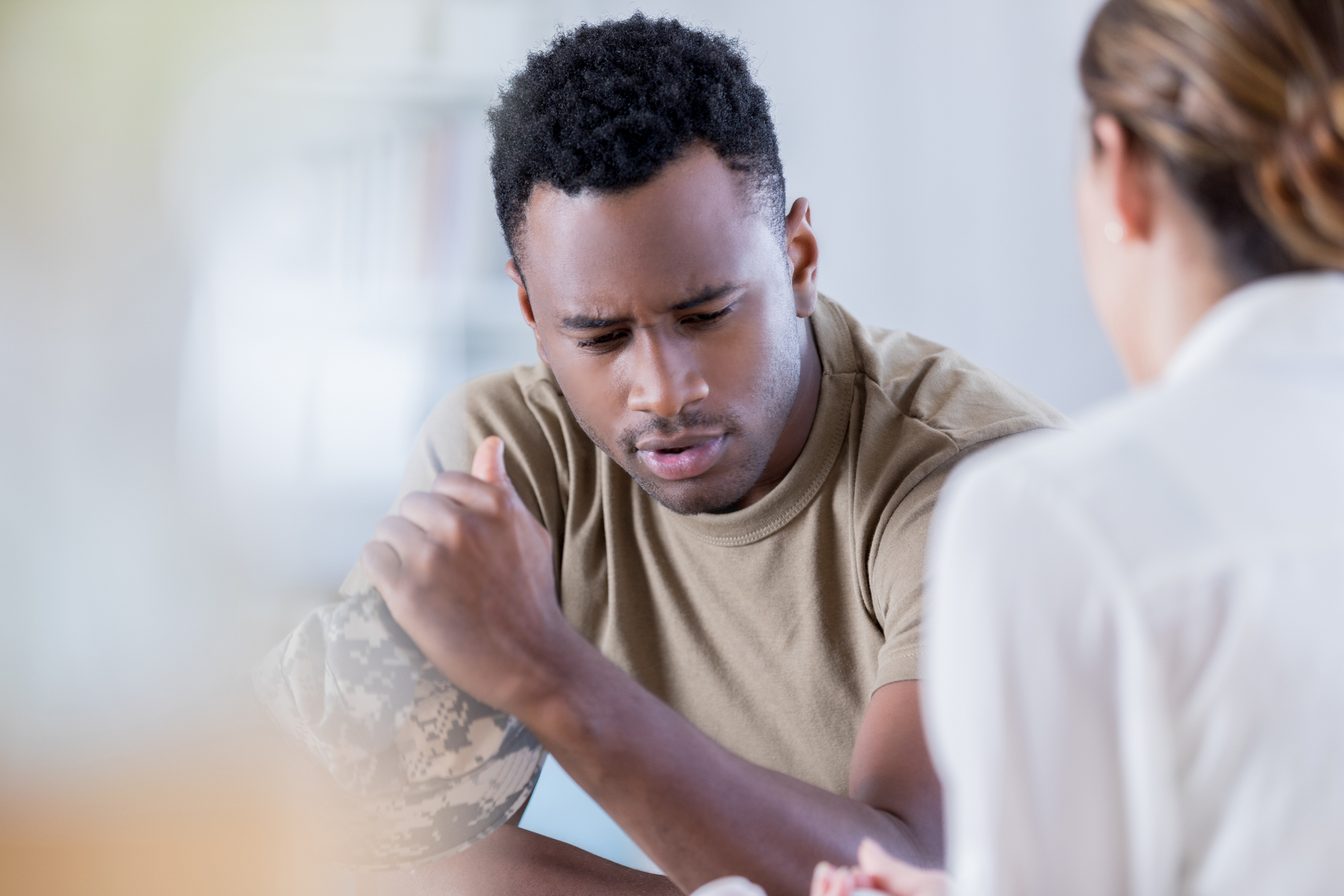 Distraught young man talks with counselor