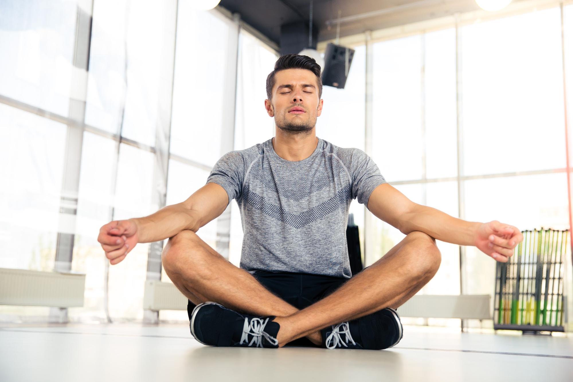 A man meditates as a form of self-care.